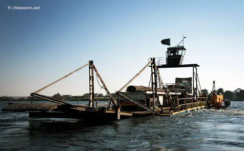 Truck ferry crossing the river