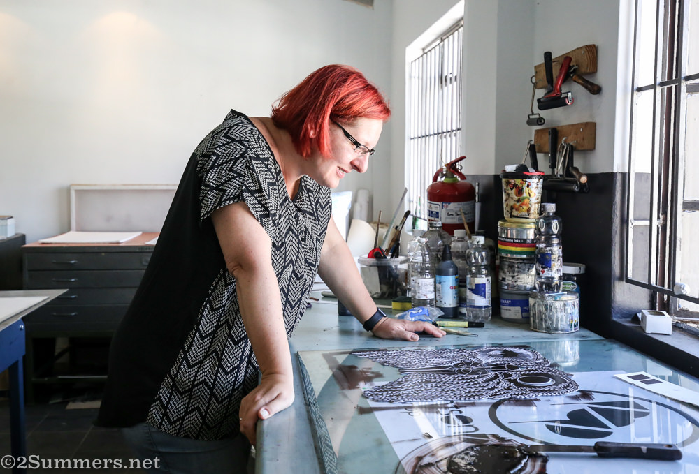 Fiver looks at her linocut.