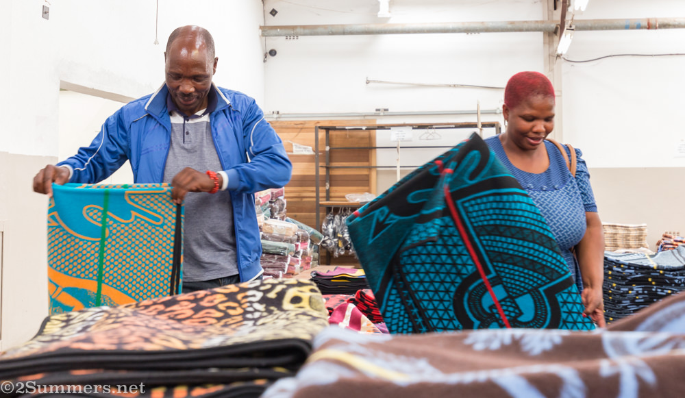 Man and woman check out blankets