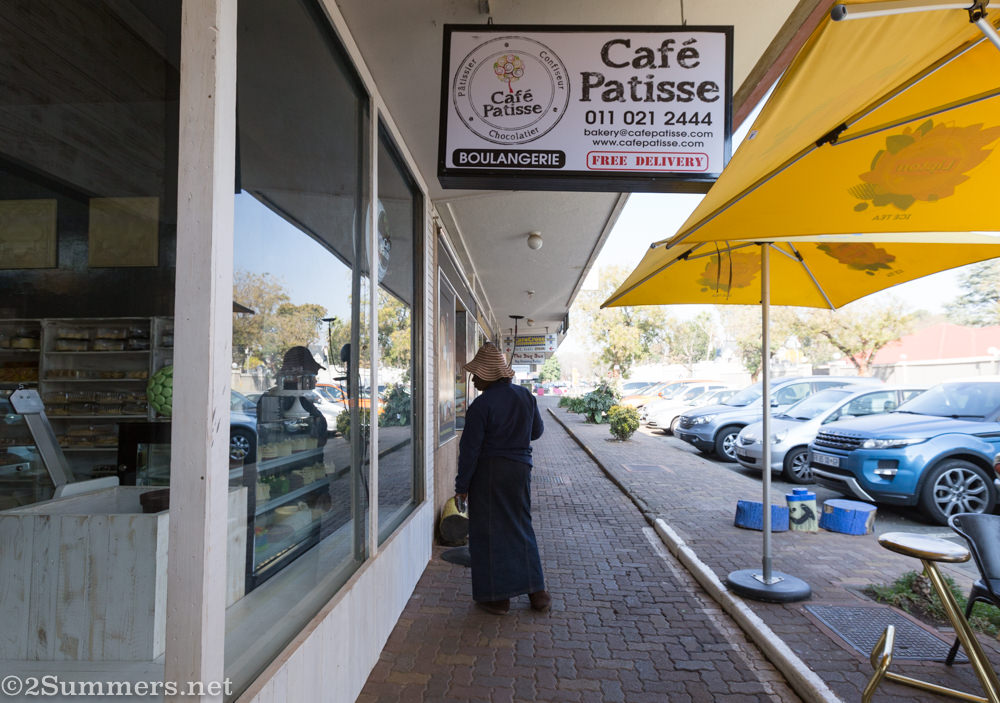 A woman looks inside Café Patisse