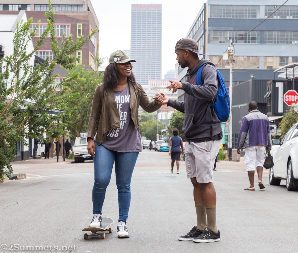 Tiffanie and Amanda practice skateboarding