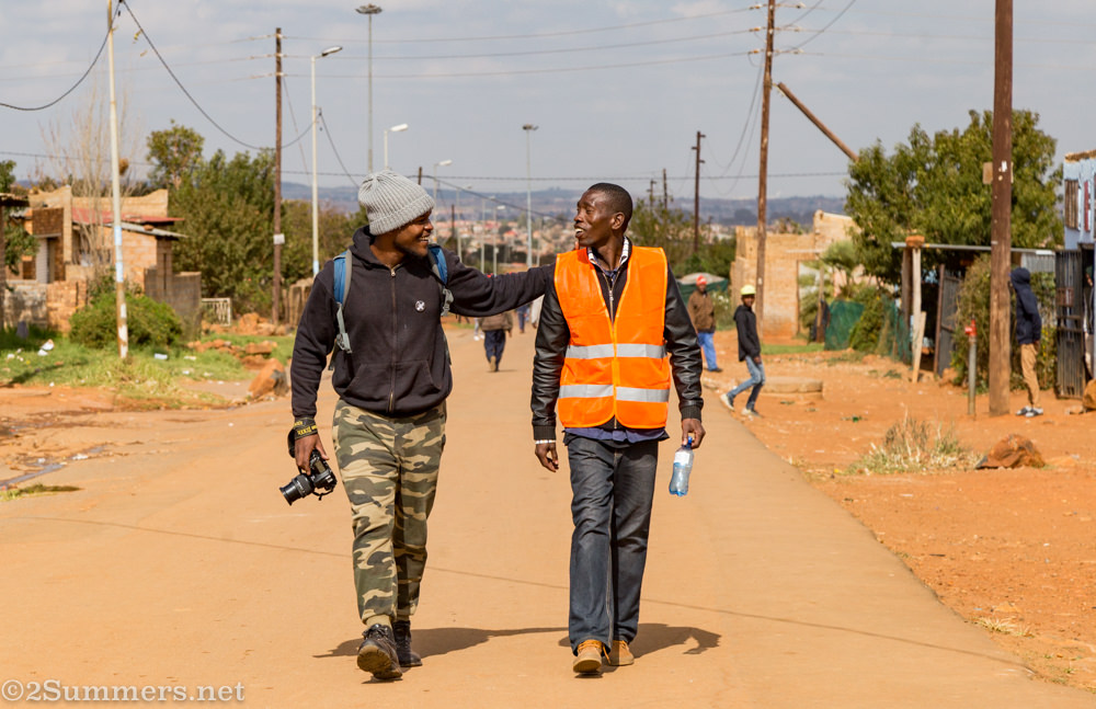 Photographer Hymie walks with Orange Farm host