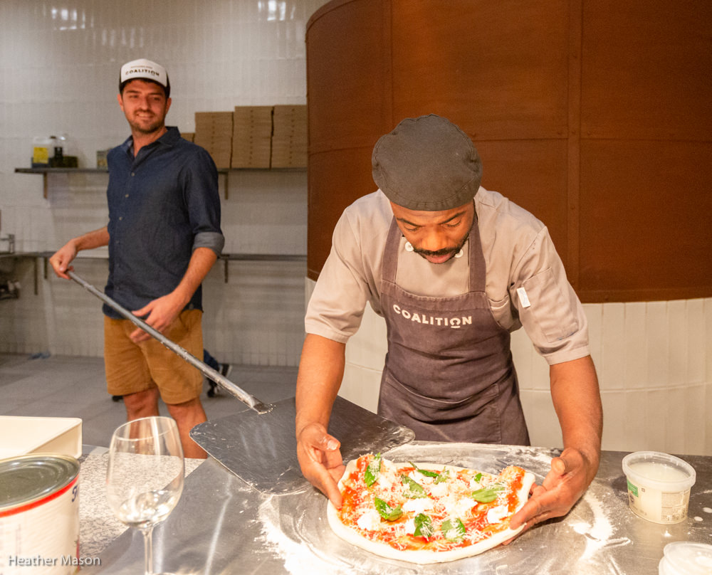 Margherita pizza going into the oven at Coalition.