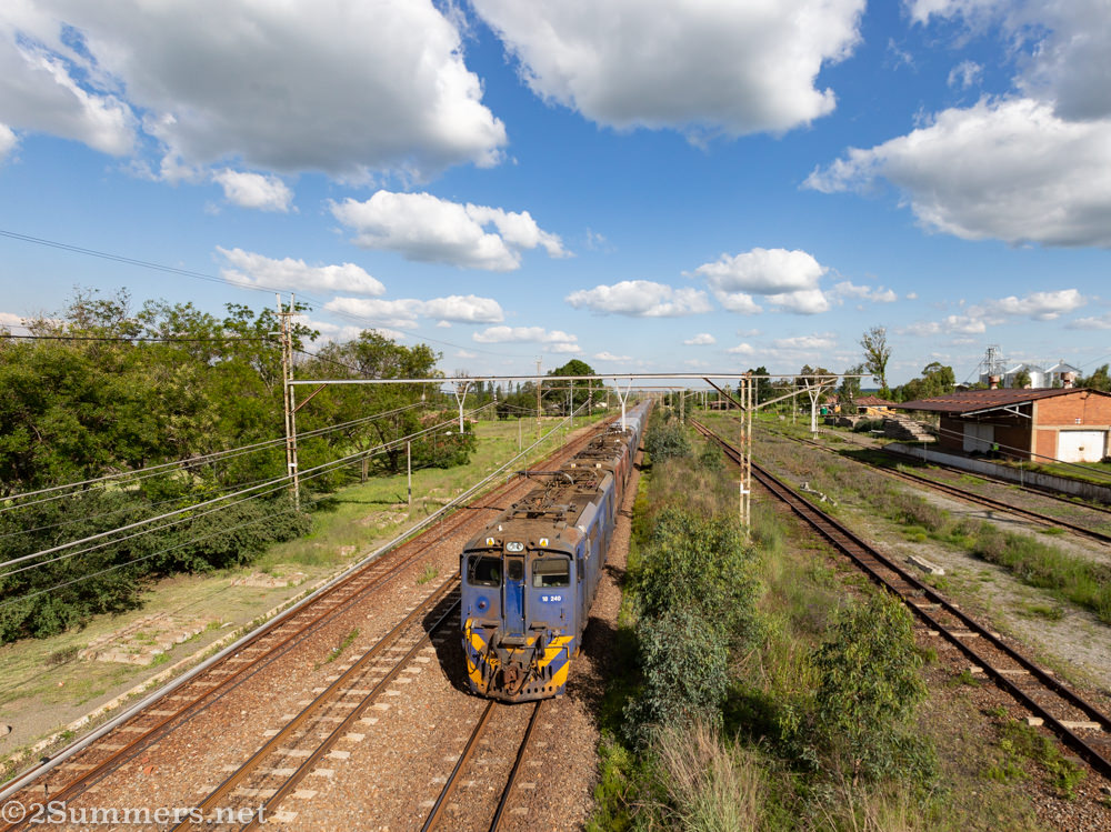 Train passing beneath a railway bridge