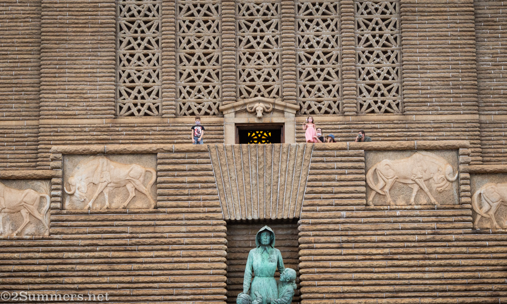 Masked family in front of the monument