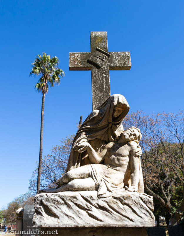 Cemetery headstone and palm tree