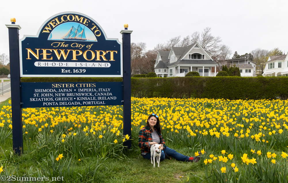 Susanna and Hundley, her dog, sitting amidst a cloud of daffodils in Newport, Rhode Island.