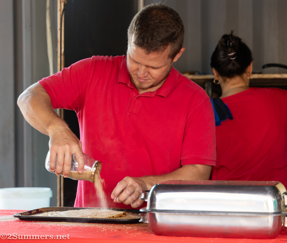 Pancake guy sugaring pancakes