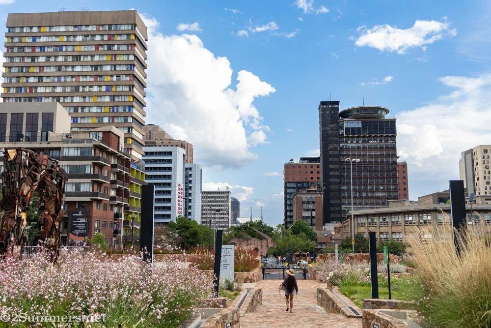A woman walks through Indwe Park in Braamfontein