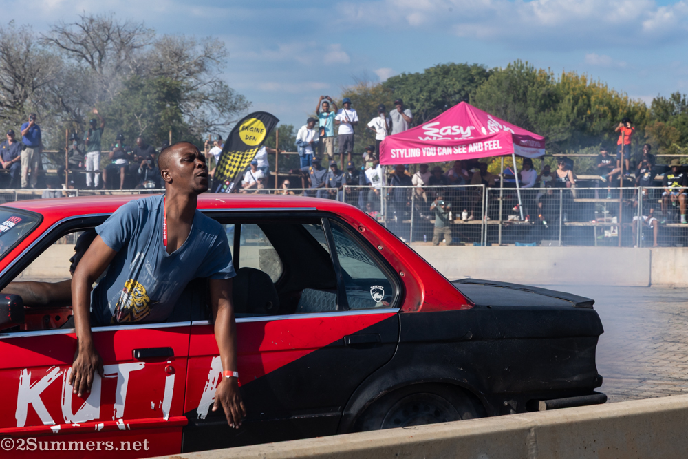 Guy leaning out of red car
