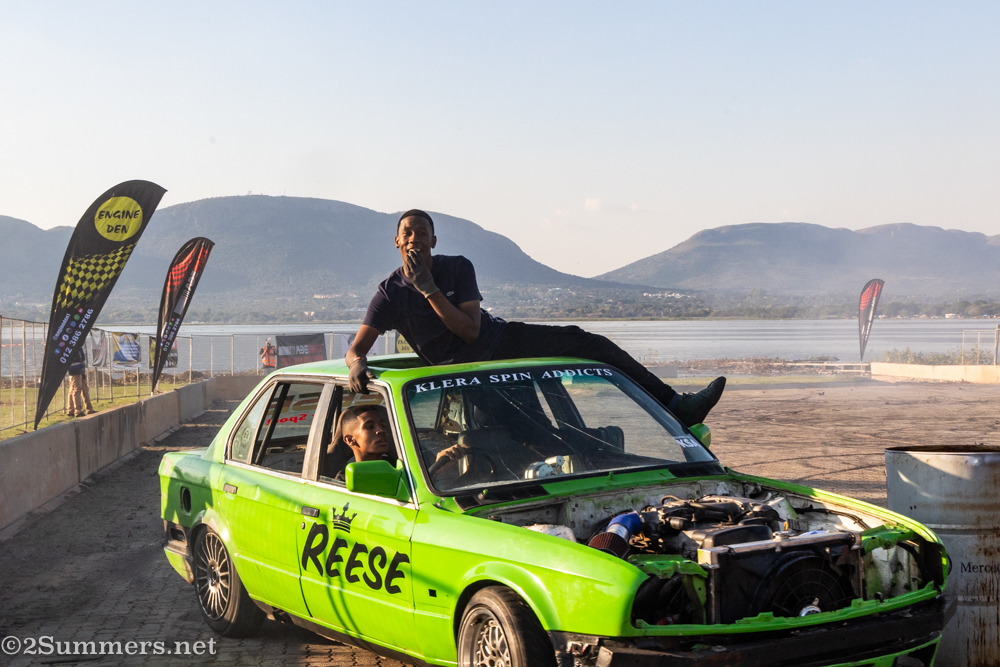 Guy on top of green car