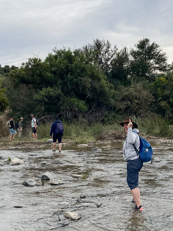 Heather crossing the river and flipping the bird
