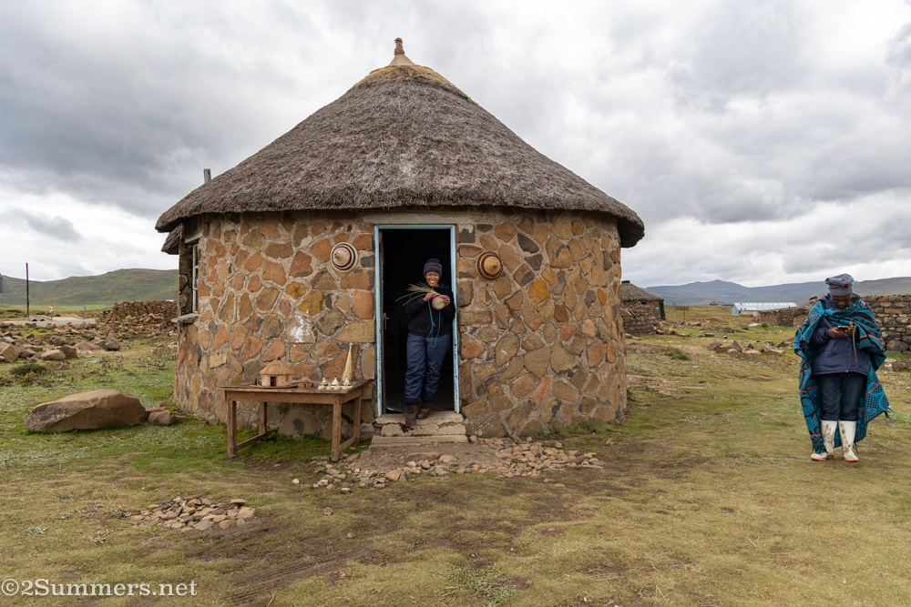 Lady weaving basket in her doorway