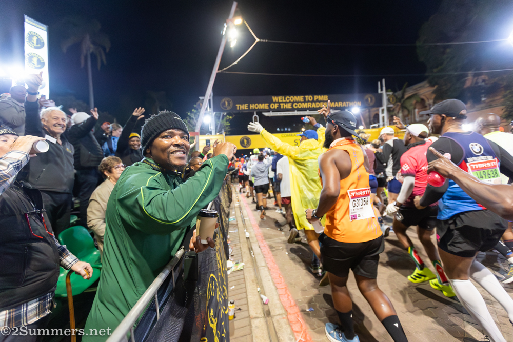 Man cheering on the runners at the start