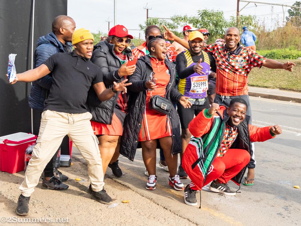 Group of supporters taking a photo with a runner