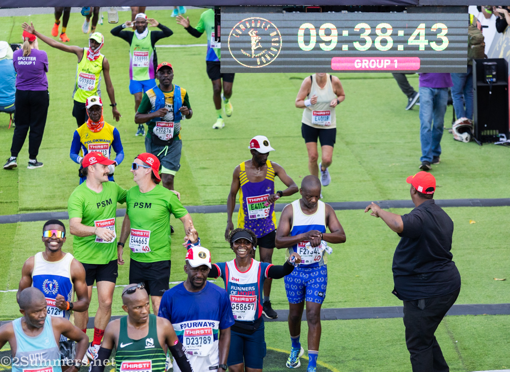 Runners celebrate as they cross the finish