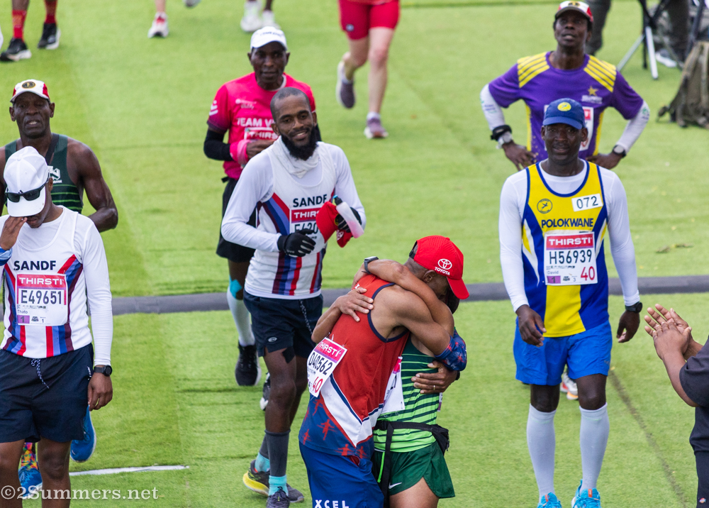 Runners celebrate as they cross the finish