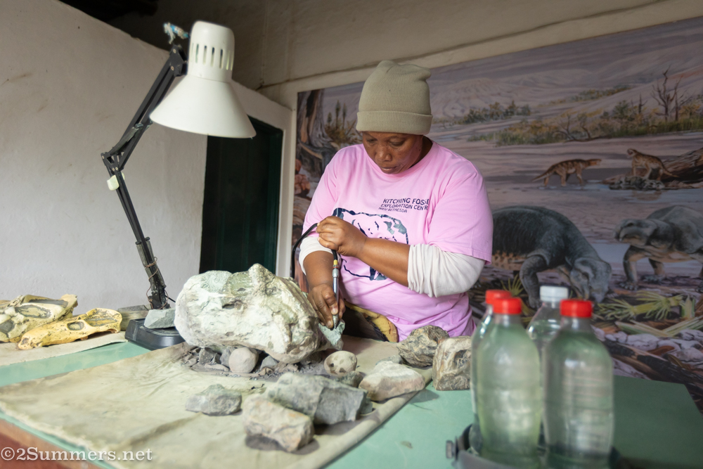 Lady drilling rock for fossils